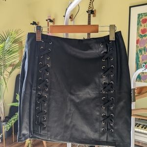 Black fake leather skirt with cross detail in front